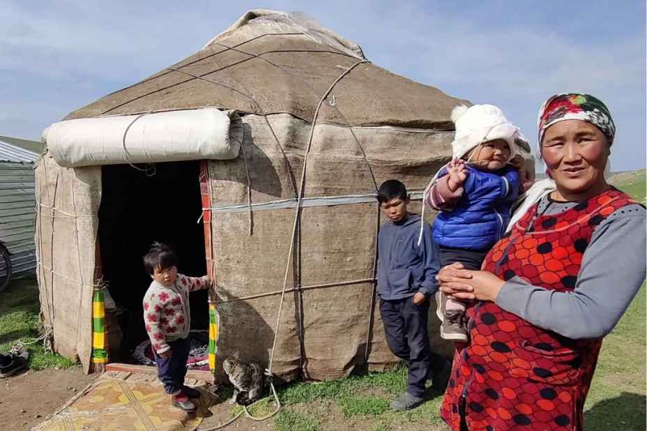 una donna e i suoi figli davanti a una yurta in kirghizistan